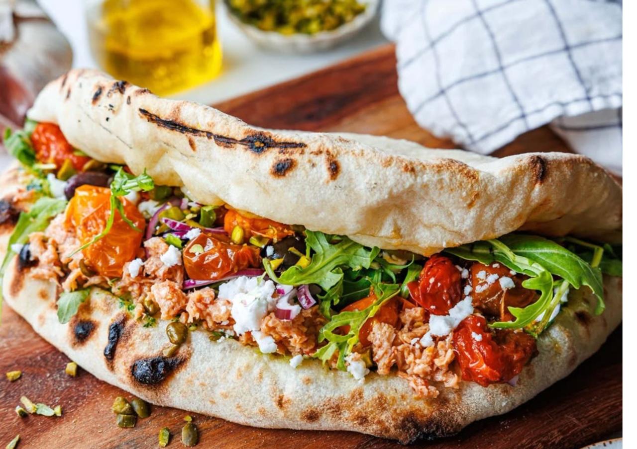 Panuozzo napolitano de Barfly con carne desmenuzada, tomates y rúcula